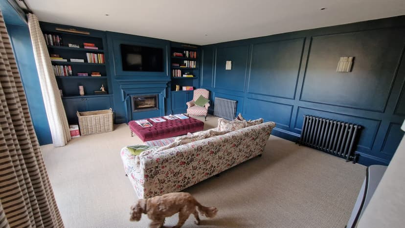 Panelled blue living room shown in Alpha Renovations’ own website gallery