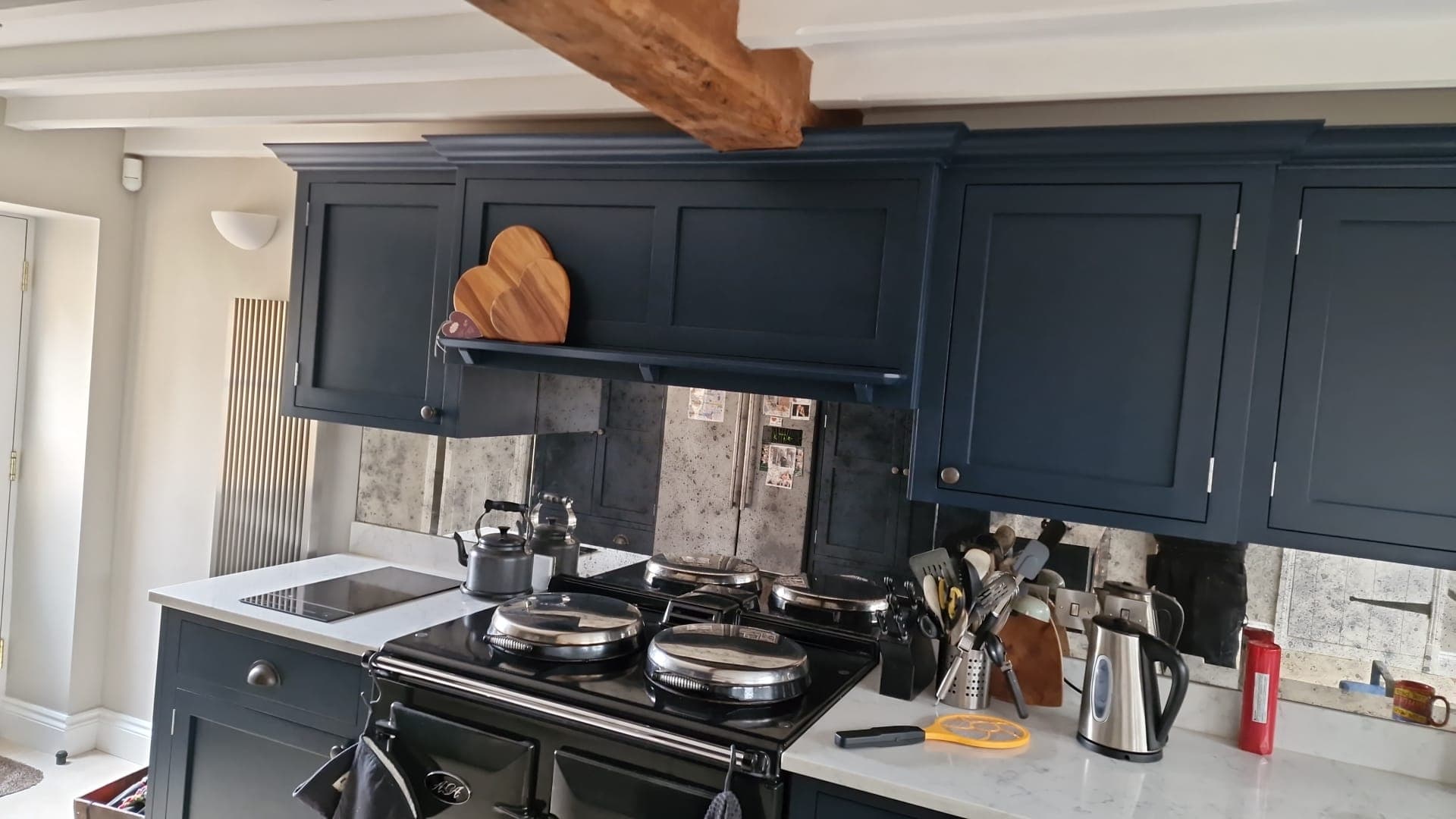 Navy painted shaker kitchen units, range cooker and marble worktop in a finished kitchen renovation