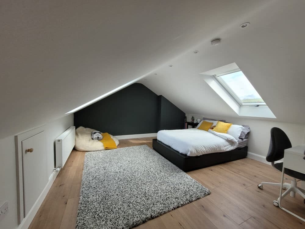 Finished loft bedroom with sloping ceilings and a roof window, from Alpha Renovations Ltd's gallery
